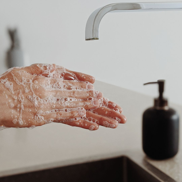 lathering soap and water at a sink lathering soap and water at a sink